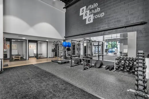 Modern fitness area with weights at Buffalo Rehab Group detox center in Buffalo.